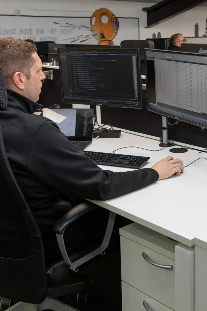 Sunrise team member working on the computer helping with Cyber Threats